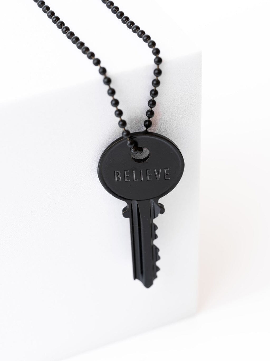 Matte Black Key Necklace With Custom Engraved Word The Giving Keys matte-black-key-necklace-with-custom-engraved-word-the-giving-keys